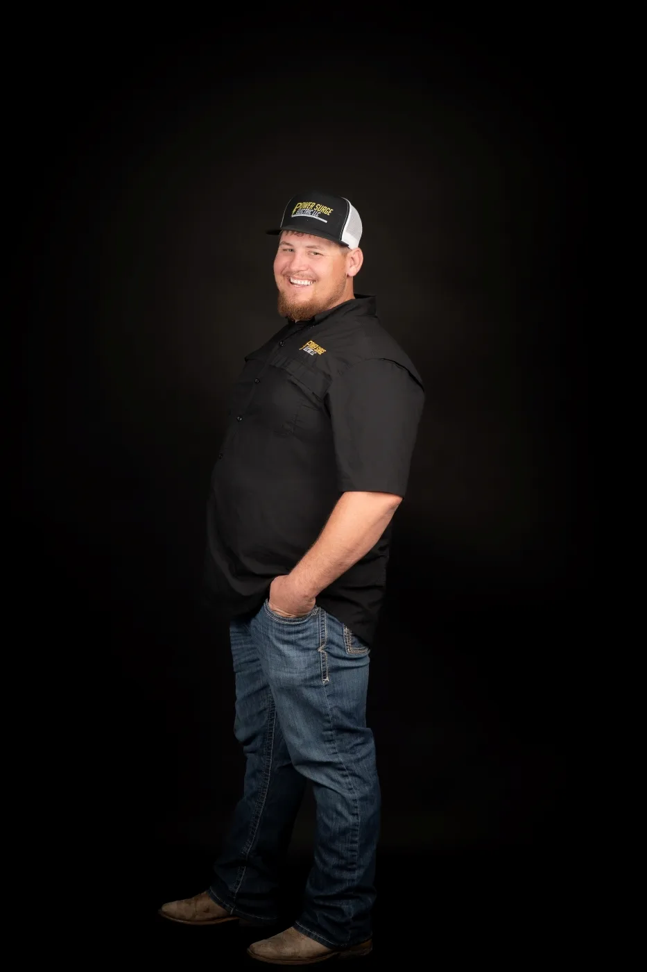 Tyler Beene, Master Electrician and owner of Power Surge Electric, in a Power Surge Electric cap and shirt.